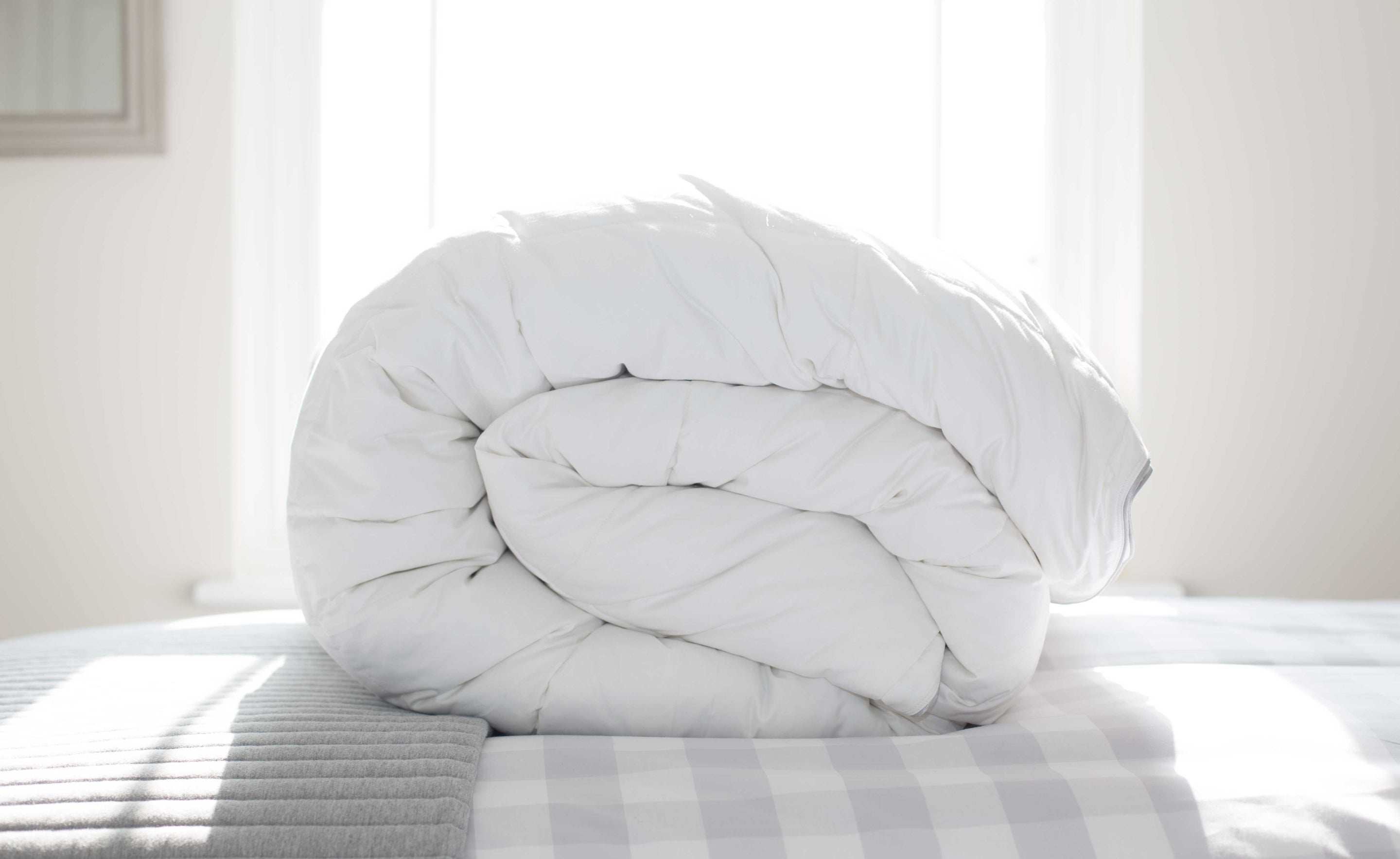 Rolled Duvet on a Check Duvet Cover in a Bedroom | Scooms