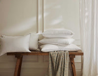 King size pillows on a wooden bench