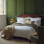 Egyptian cotton bedding in white on a made bed in a luxurious bedroom. | Scooms