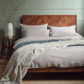 Linen bedding in grey on a bed. Scooms