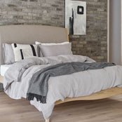 Grey linen bedding on a bed. Scooms