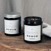 Natural scented soy wax candles on a wooded stool. Scooms