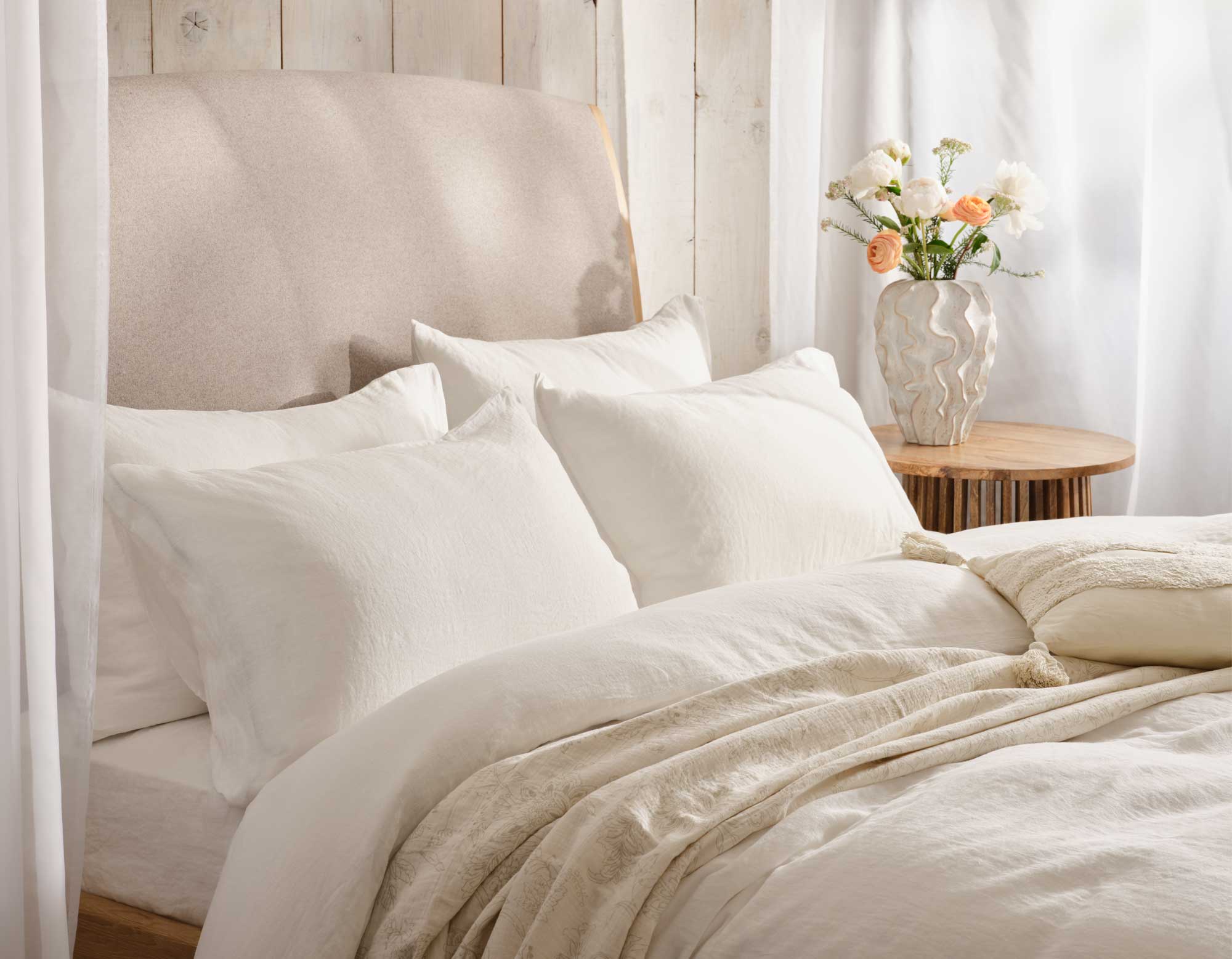 White linen bedding on bed | Scooms