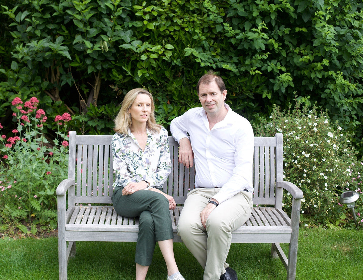 Emily and Jonathan, Scooms founders, sitting on a bench in their garden | Scooms