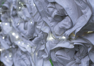 Piles of Rolled Duvets at Night | scooms