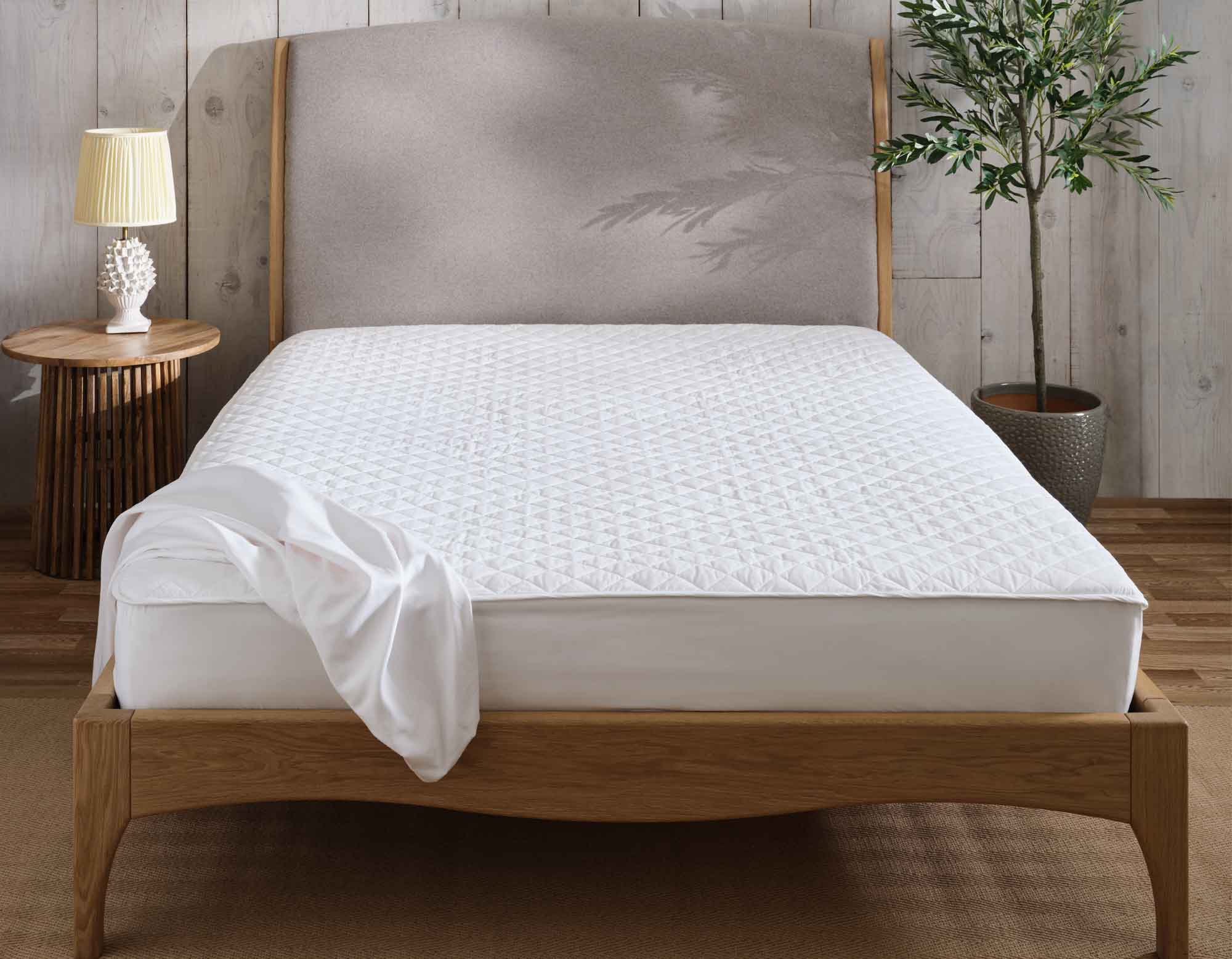 Mattress protector on bed in bedroom