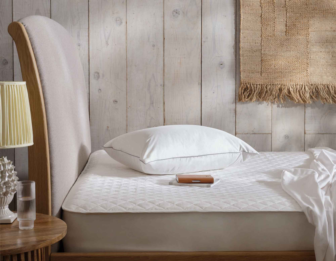 Cotton mattress protector on bed | Scooms