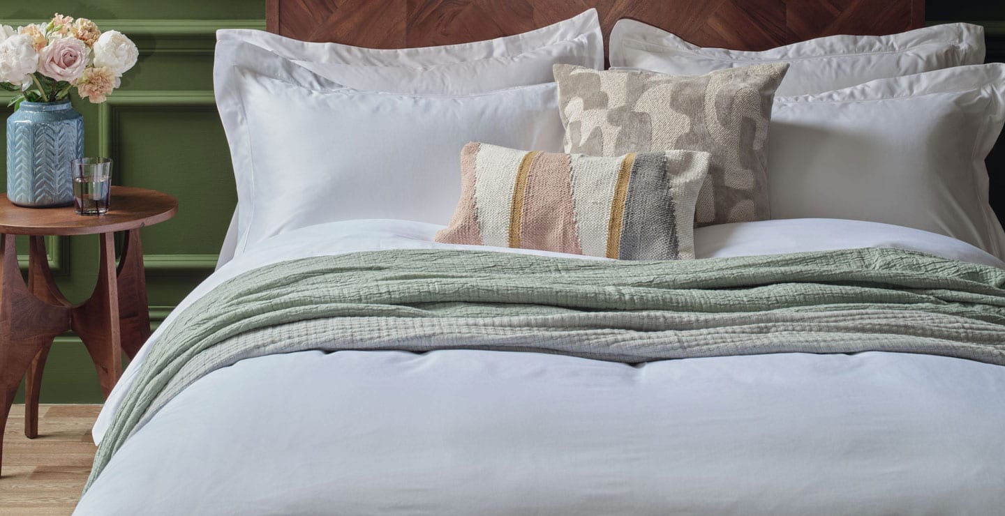 Egyptian Cotton Sheets in White on a Bed. Scooms