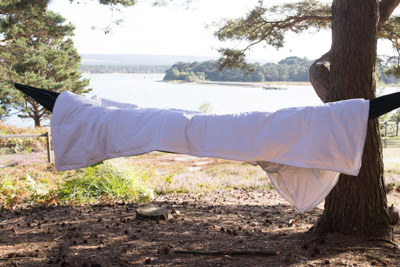 Hammock Between 2 Trees with a Summer Duvet Laid On It | Scooms