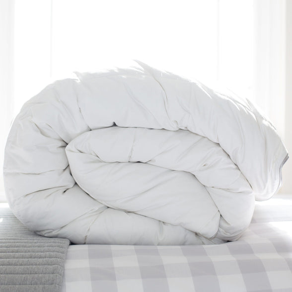 Hungarian goose down duvet, rolled, on bed