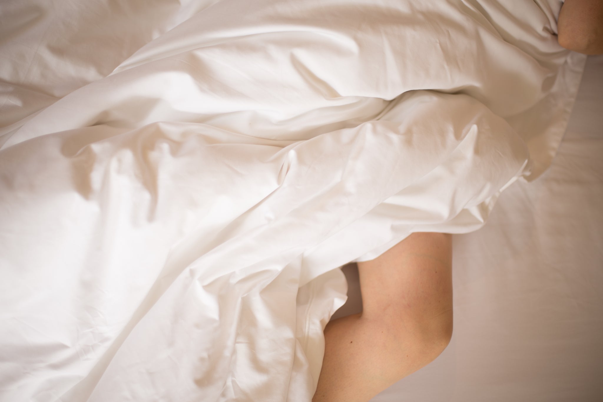 Legs Showing From Under a Duvet | scooms