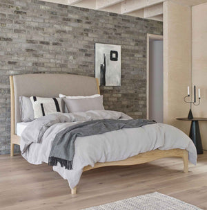 Natural linen bedding in grey on made bed in Scandi style bedroom