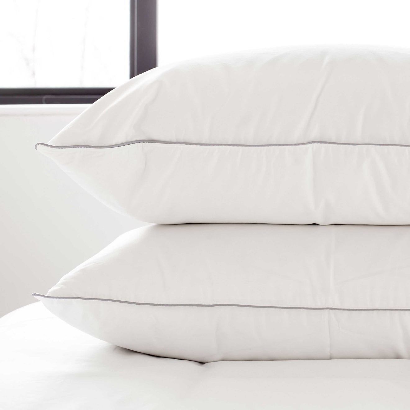A pair of standard size pillows on a bed