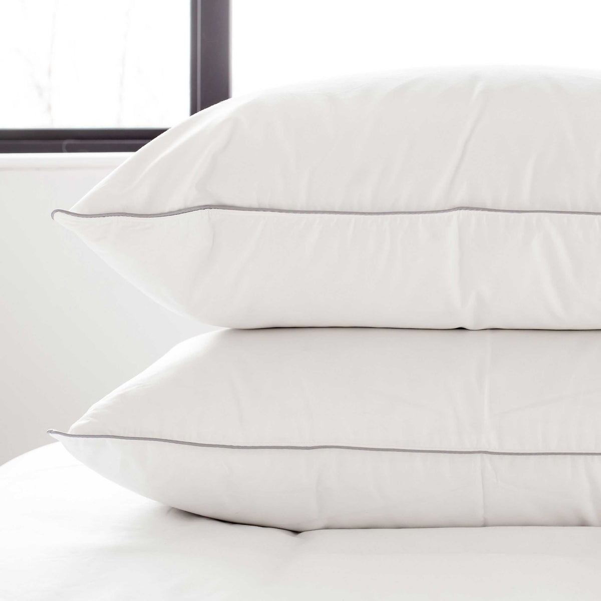 A pair of standard size pillows on a bed