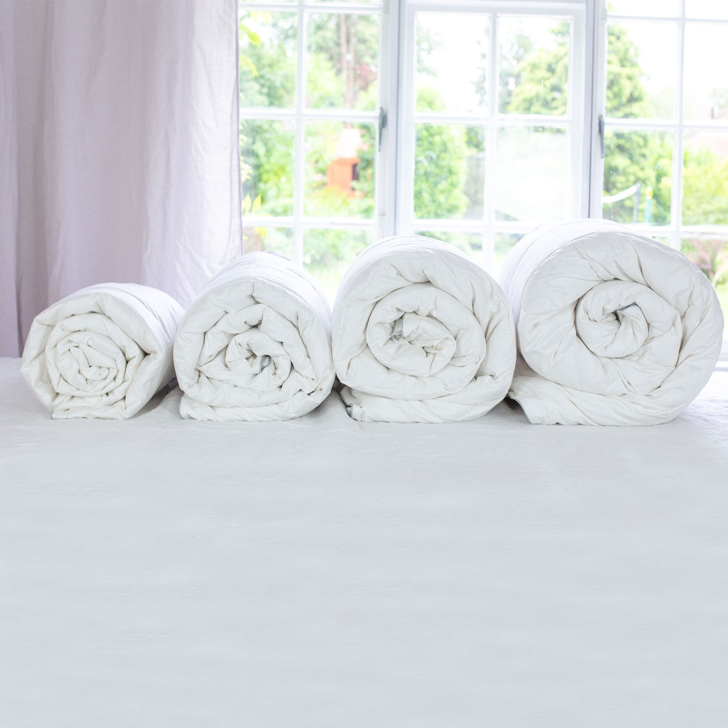 4 Rolled Duvets with Different Duvet Togs | scooms