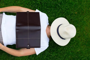 Person Napping Lying on Grass with a Book | scooms