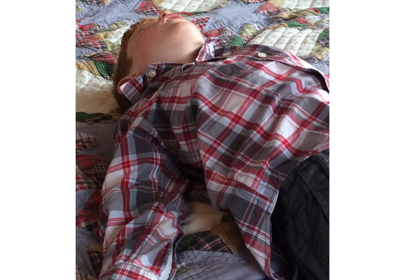 Sleeping child on Bed | Scooms