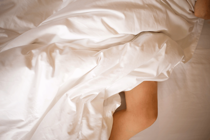 Person Under A Winter Duvet With Legs Showing | Scooms