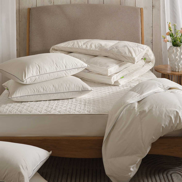 Duvet, pillows, topper & mattress protector on bed | scooms