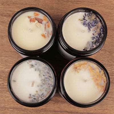 Natural scented candles decorated with herbs and spices 