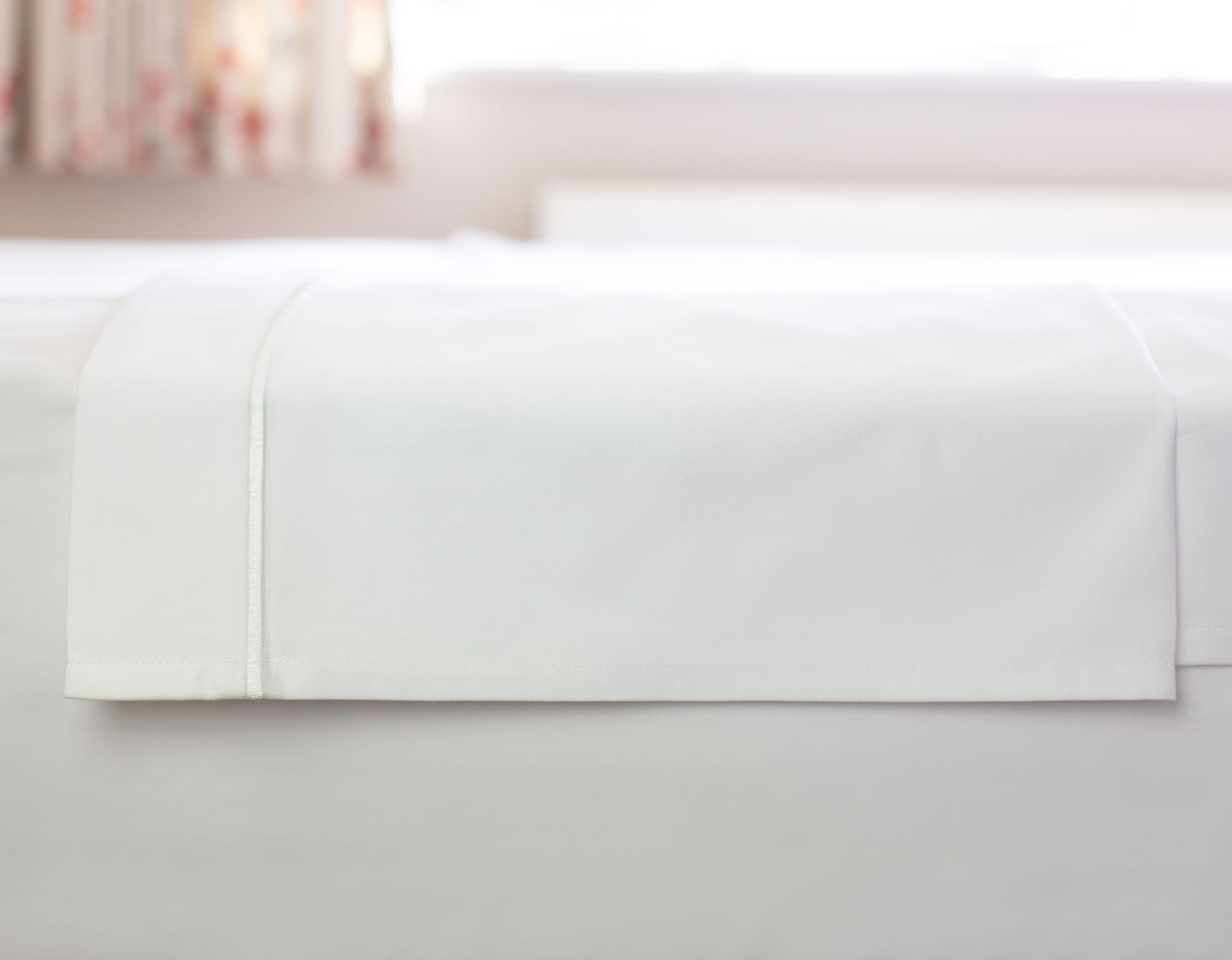 White Egyptian cotton flat sheet folded showing oxford border with marrow stitching