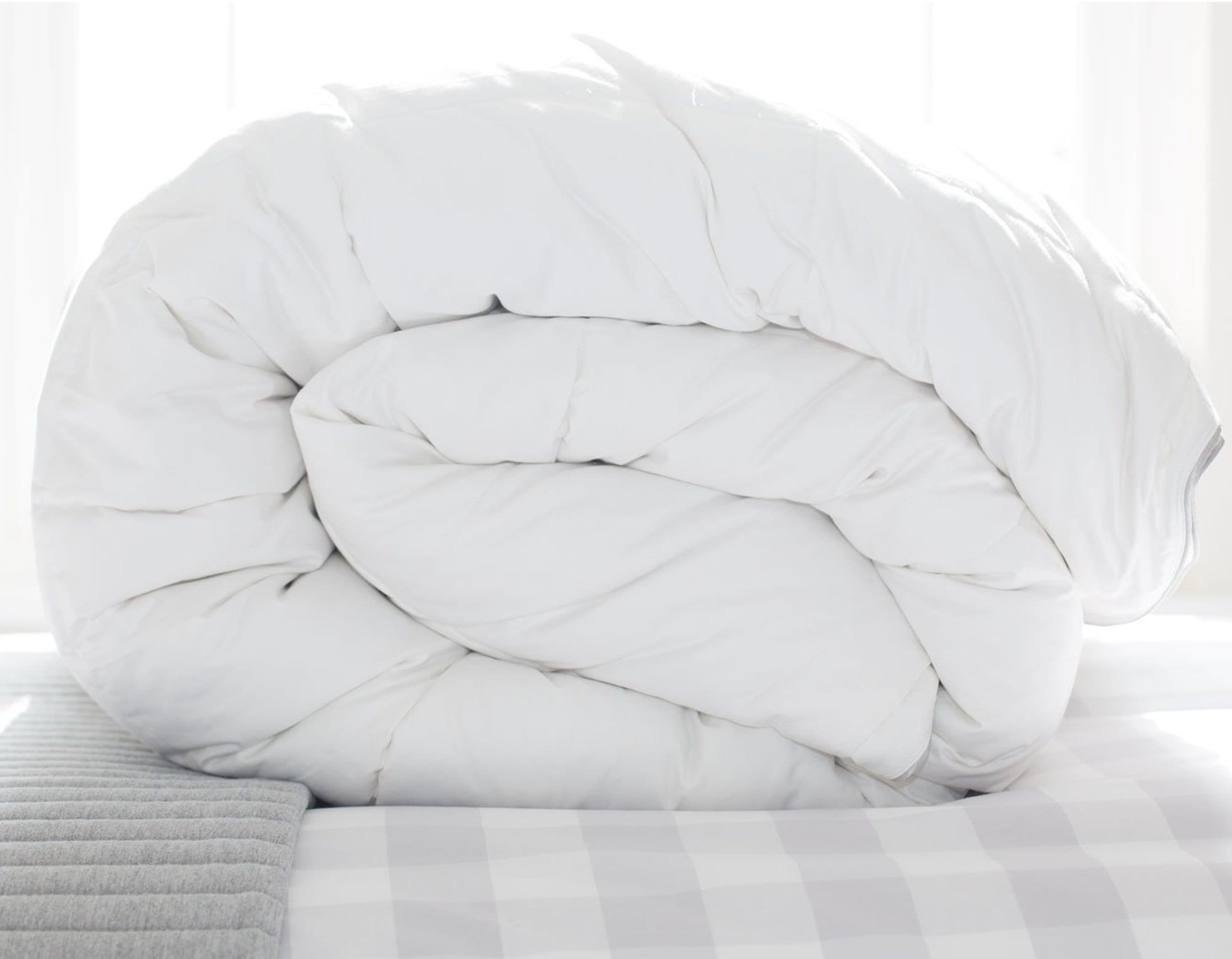 Superking 13.5 tog all seasons Hungarian goose down duvet rolled on bed