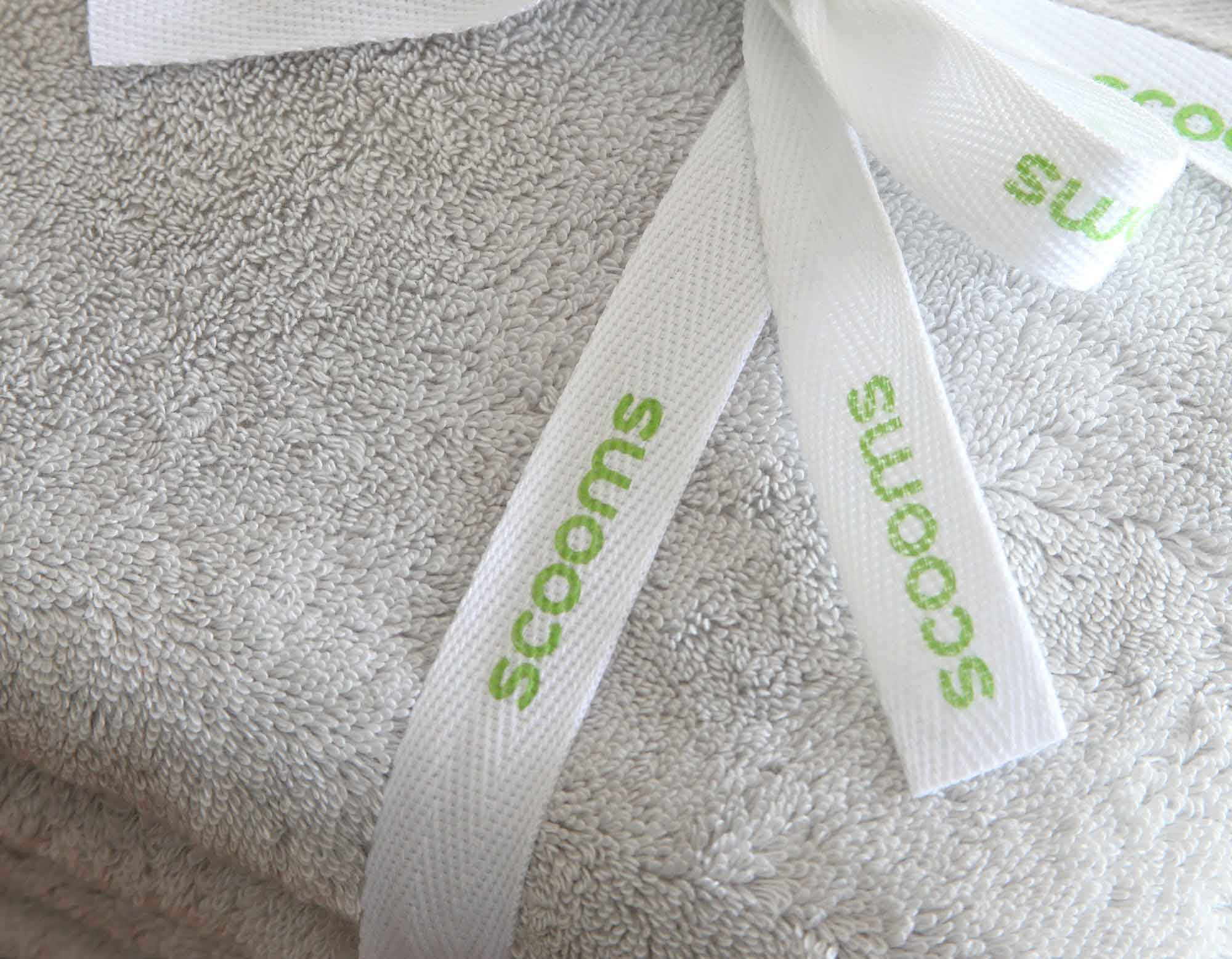 Cotton bath sheet in pearl grey folded and tied with scooms branded ribbon