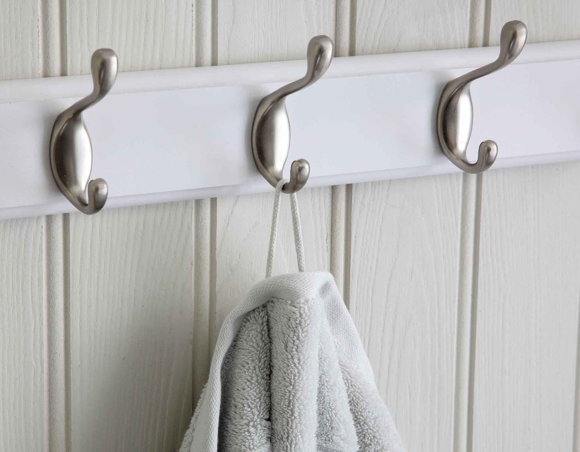 Pearl grey bath towel hanging from a wall hook by cotton loop