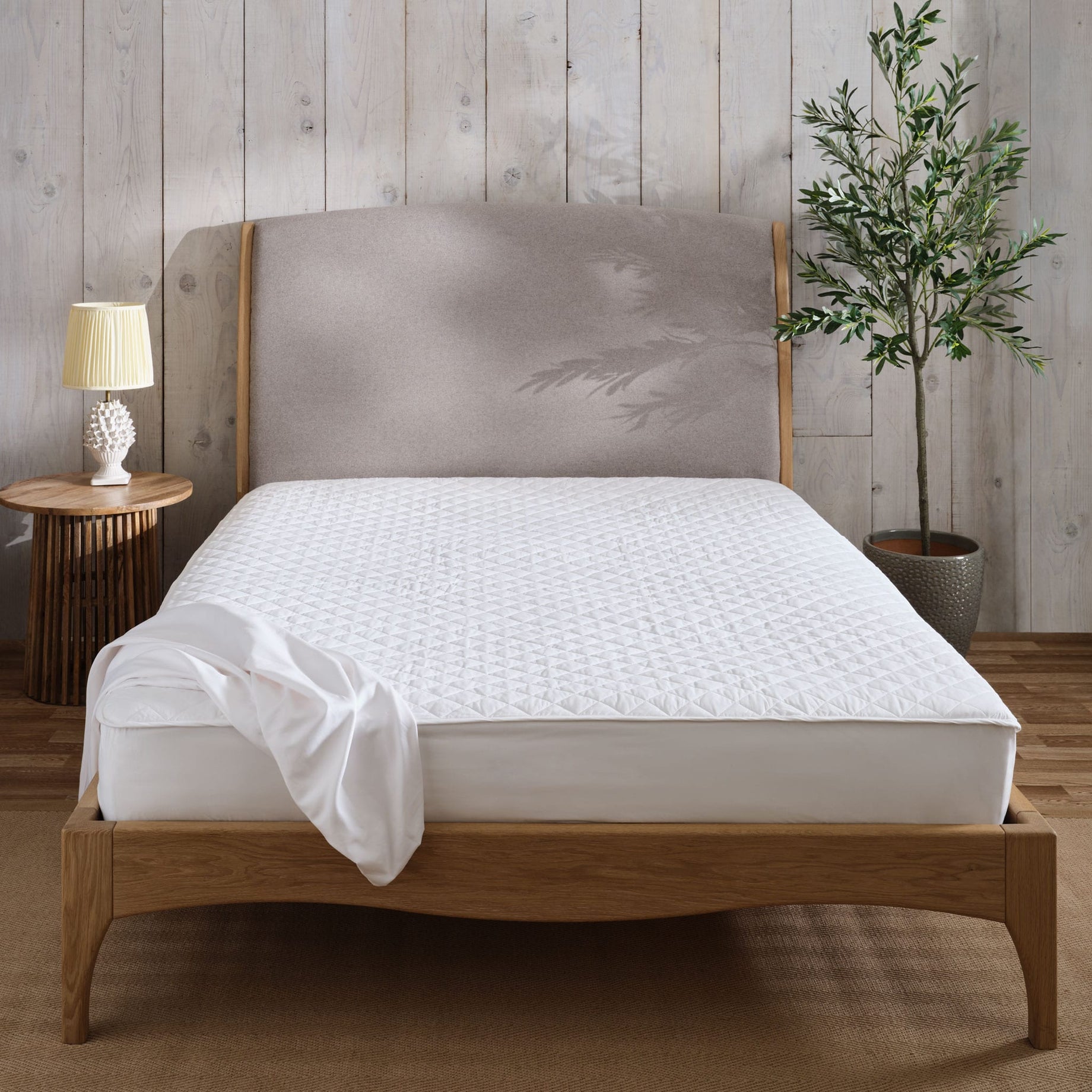 Mattress protector on a mattress and bed. Scooms