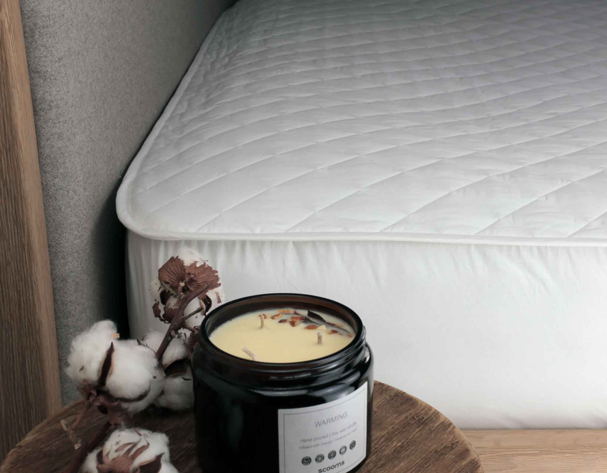 Cotton Mattress Protector on Bed with Natural Candle