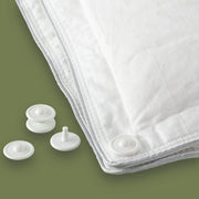 Duvet fasteners next to a duvet. Scooms