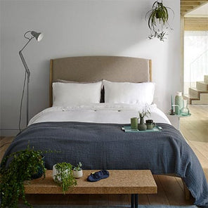 White linen bedding set on a bed in a Scandi style bedroom.  Scooms