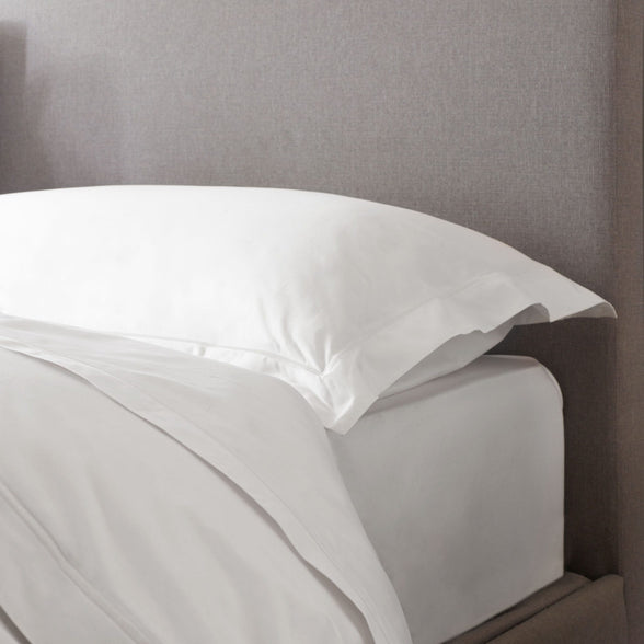 White Egyptian cotton bedding. Showing corner of sheets, duvet cover and pillowcase on bed. | Scooms
