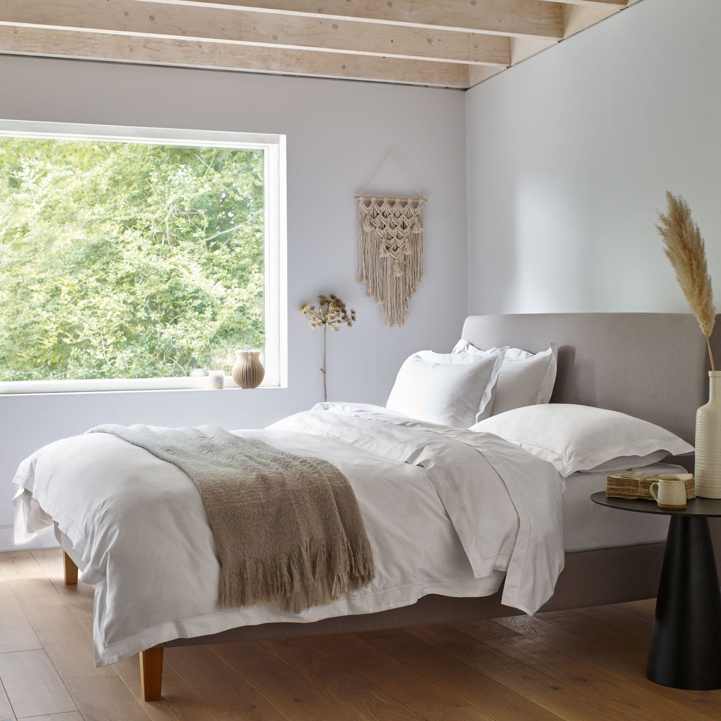 Egyptian cotton bed linen in White on a made bed in a Scandi style bedroom. | Scooms
