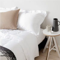 White Egyptian cotton bedding on a bed with a side table | Scooms
