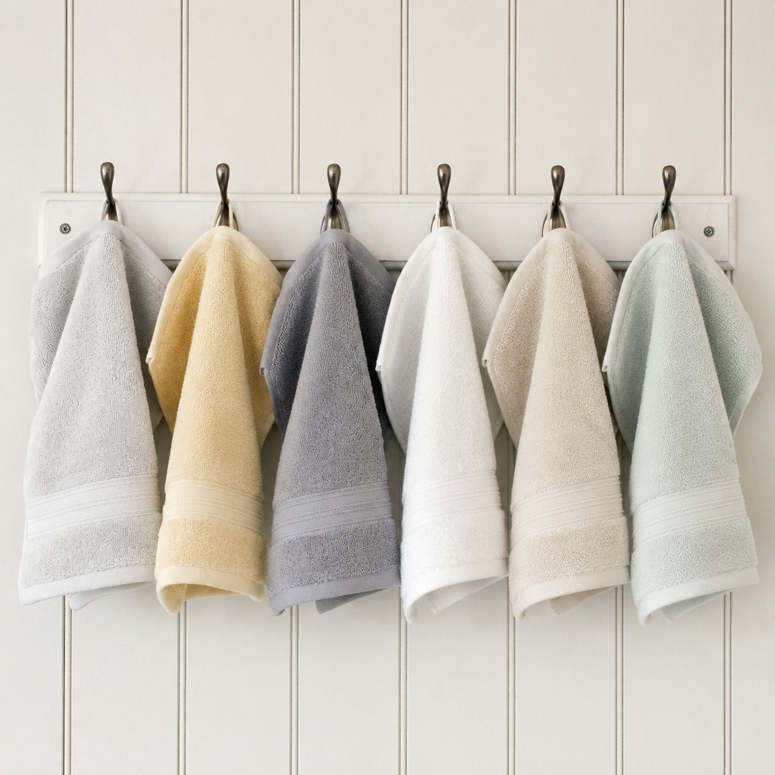 Egyptian cotton face cloths in grey, white, green, natural and creme hanging in bathroom | Scooms