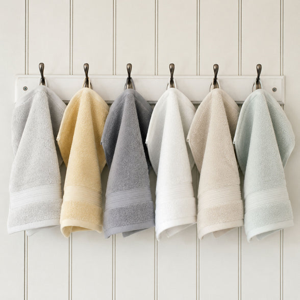 Egyptian cotton face cloths in grey, white, green, natural and creme hanging in bathroom | Scooms