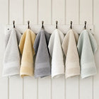 Egyptian cotton face cloths in grey, white, green, natural and creme hanging in bathroom | Scooms