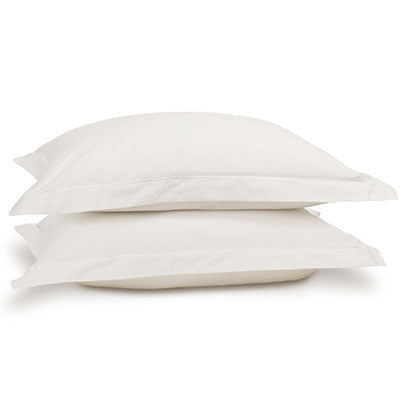 Egyptian cotton pillowcase pair in white on pillows. Scooms
