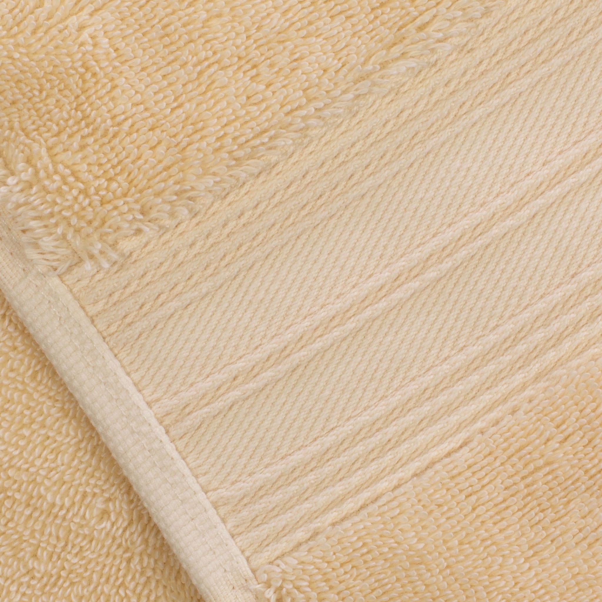Creme Egyptian cotton towel detail, featuring the towel border and double stitching. Scooms