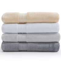 White, silver grey, pearl grey, and creme Egyptian cotton towels in a pile. | Scooms