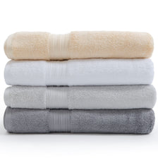 White, silver grey, pearl grey, and creme Egyptian cotton towels in a pile. | Scooms