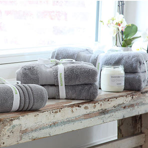 Grey Egyptian cotton bath towels, bath sheets and a bath mat on shabby chic bench. Scooms