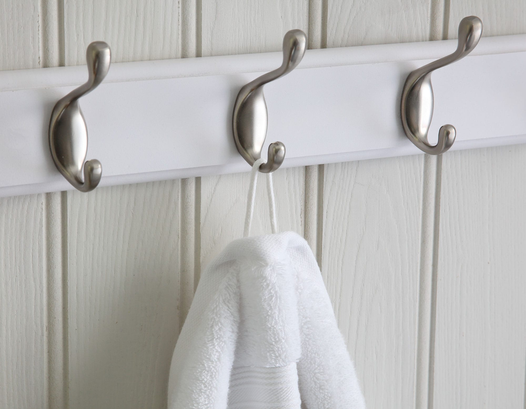 Egyptian cotton hand towel hanging from hook on wall