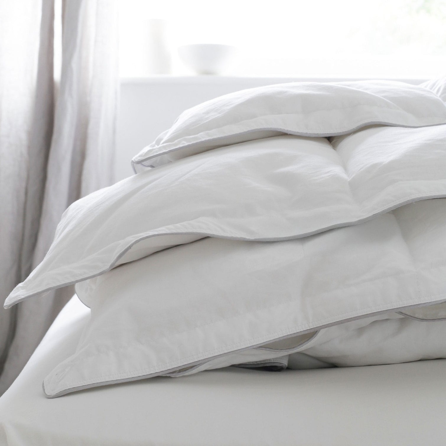 Folded Hungarian goose down duvet on bed. | Scooms