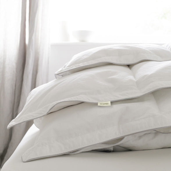 Folded Hungarian goose down duvet on bed. | Scooms