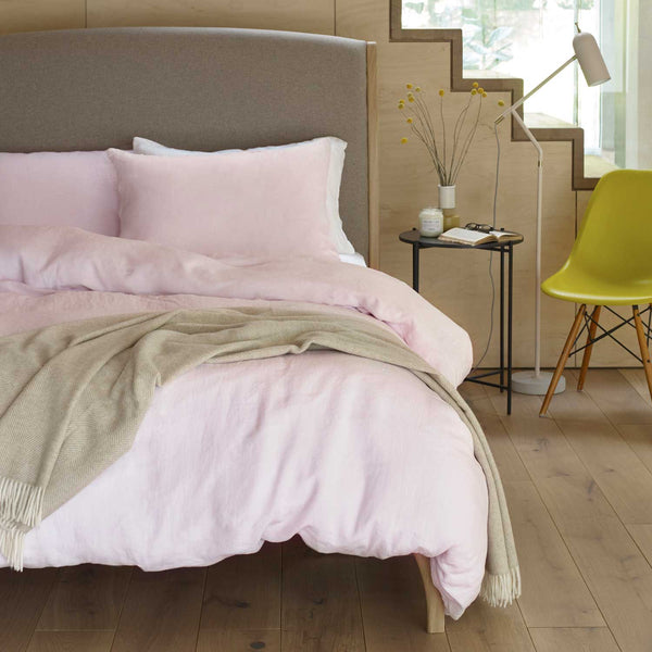 Luxury pink linen bedding on bed with natural brown merino lambswool throw | Scooms
