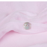 Pink linen duvet cover showing mother of pearl button details. Scooms