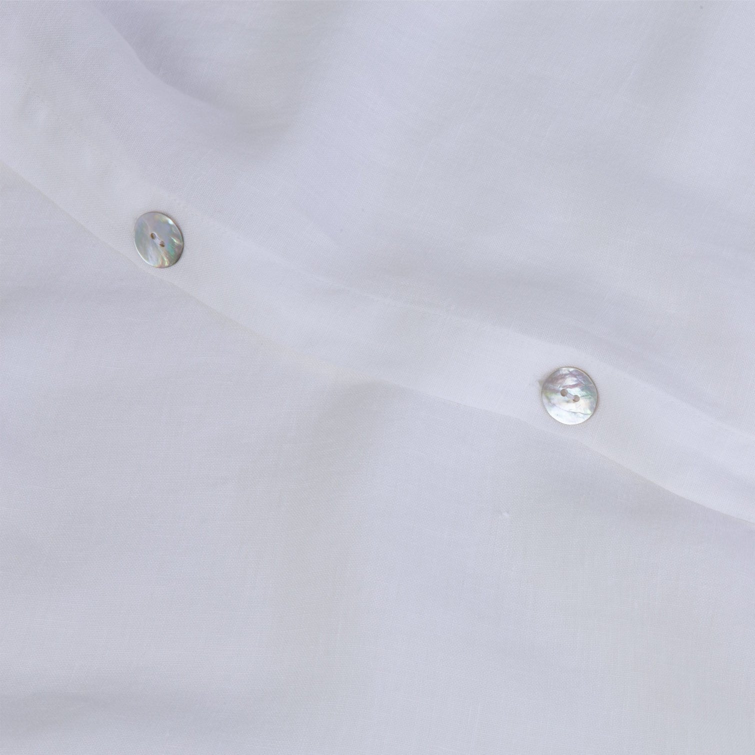 White linen duvet cover showing the button details. Scooms