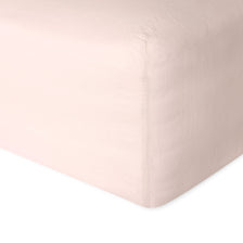 Linen fitted sheet in pink showing the corner detail. Scooms